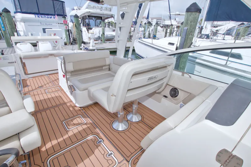 Slide: The Image of 2017 Boston Whaler 320 Vantage interior with teak flooring and comfortable seating. - 50