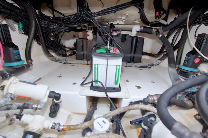 Slide: The Image of Engine compartment of a 2017 Boston Whaler 320 Vantage with visible wiring and components. - 57