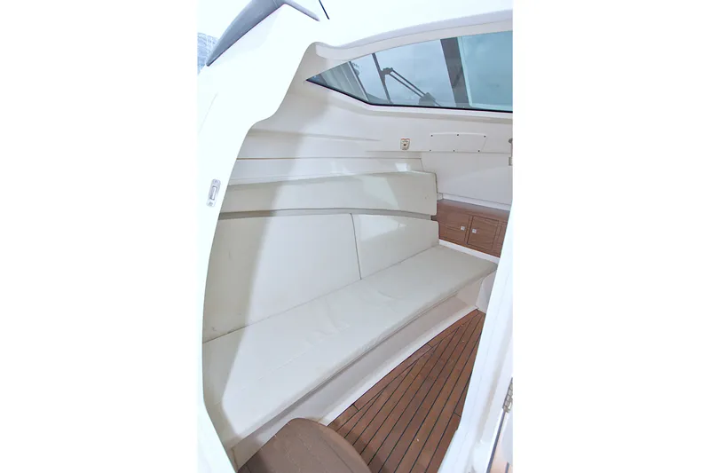 Slide: The Image of Interior cabin of 2017 Boston Whaler 320 Vantage with cushioned seating and wooden flooring. - 31