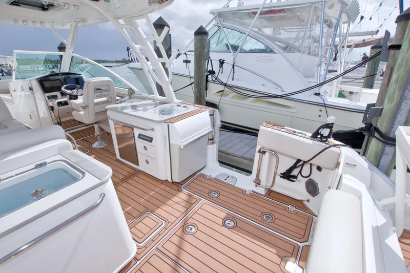 Slide: The Image of 2017 Boston Whaler 320 Vantage boat interior with teak flooring and modern amenities. - 21