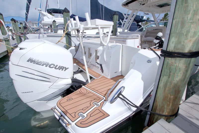 Slide: The Image of 2017 Boston Whaler 320 Vantage docked, featuring Mercury Verado outboard engine. - 16
