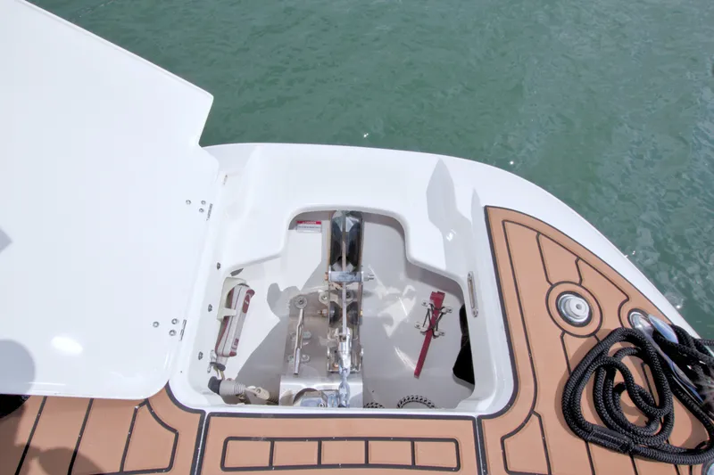 Slide: The Image of Open storage compartment on 2017 Boston Whaler 320 Vantage boat, featuring deck and water view. - 43