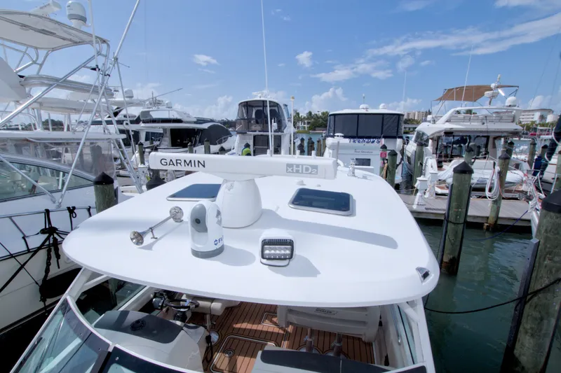 Slide: The Image of 2017 Boston Whaler 320 Vantage docked, featuring Garmin equipment on the deck. - 44