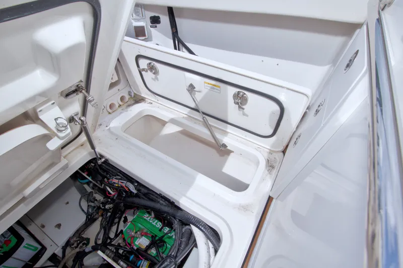 Slide: The Image of 2017 Boston Whaler 320 Vantage storage compartment and wiring detail. - 54