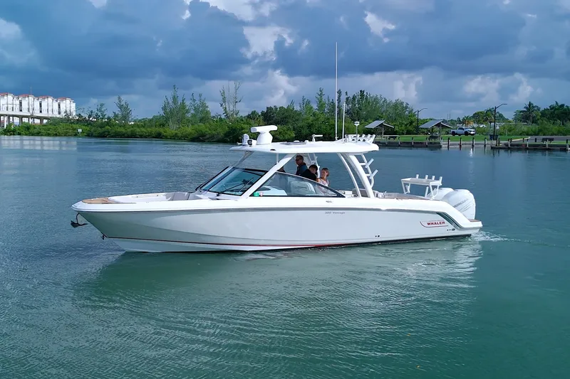 The Image of 2017 Boston Whaler 320 Vantage boat cruising on calm water under cloudy skies. - 0