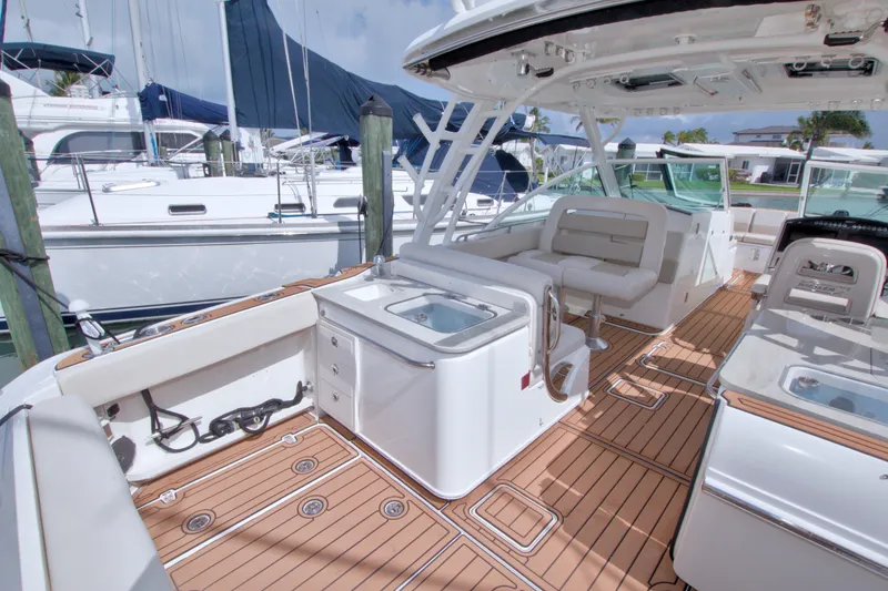 Slide: The Image of 2017 Boston Whaler 320 Vantage boat interior with teak flooring and seating area. - 23