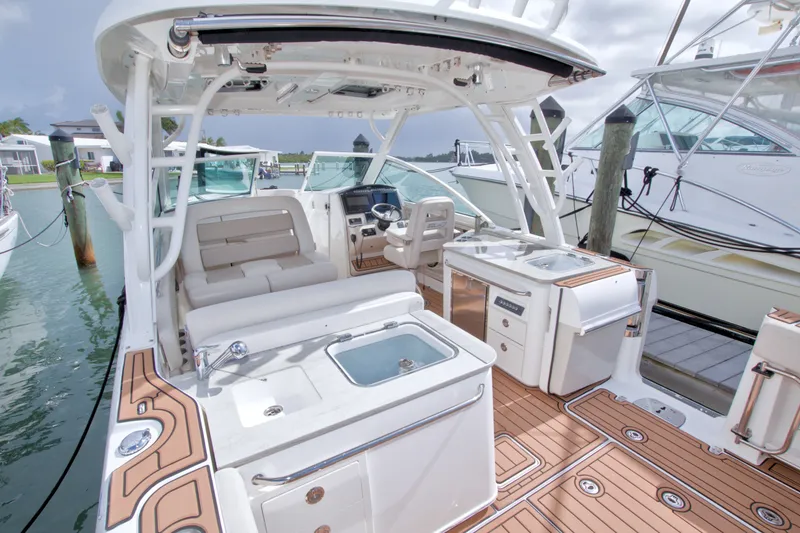Slide: The Image of 2017 Boston Whaler 320 Vantage boat interior with seating and helm station. - 22