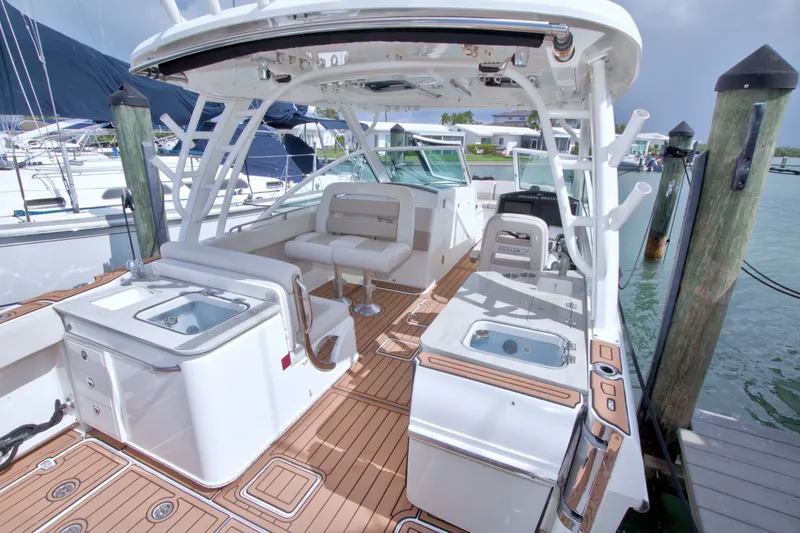 Slide: The Image of 2017 Boston Whaler 320 Vantage boat docked, featuring spacious seating and modern amenities. - 26