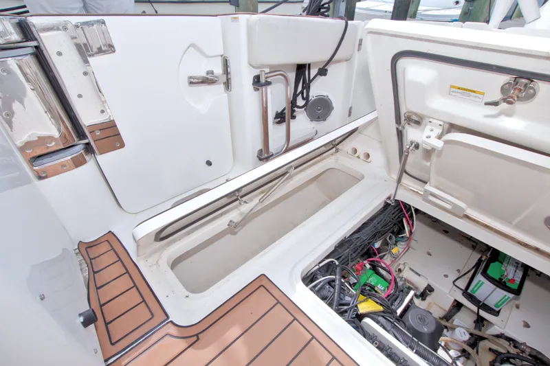 Slide: The Image of 2017 Boston Whaler 320 Vantage boat interior showing storage and wiring compartments. - 52