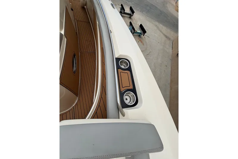 Slide: The Image of 2021 Scout 305 LXF boat interior with wood accents and cup holders. - 32