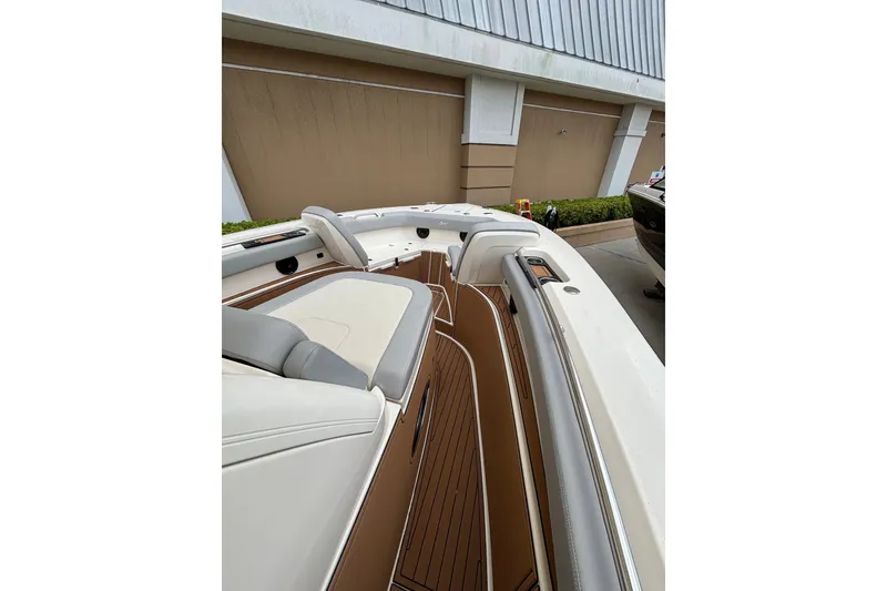 Slide: The Image of 2021 Scout 305 LXF boat interior with sleek seating and wood finish. - 23