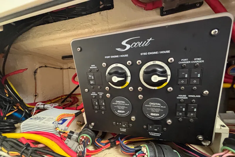 Slide: The Image of Control panel of a 2021 Scout 305 LXF boat with wiring and switches. - 42