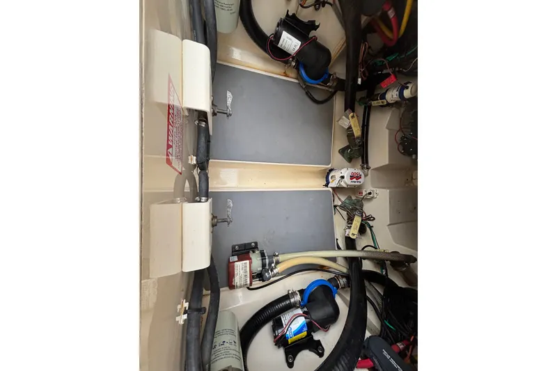 Slide: The Image of 2021 Scout 305 LXF boat interior showing wiring and mechanical components. - 43
