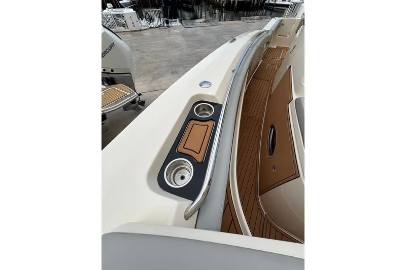 Slide: The Image of 2021 Scout 305 LXF boat deck with cup holders and teak flooring. - 31