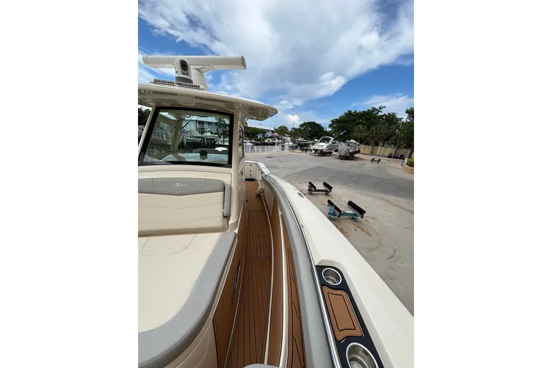 Slide: The Image of 2021 Scout 305 LXF boat docked, showcasing sleek design and luxurious interior. - 29