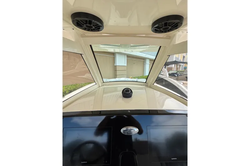 Slide: The Image of Interior view of 2021 Scout 305 LXF boat dashboard with speakers and Garmin screens. - 39
