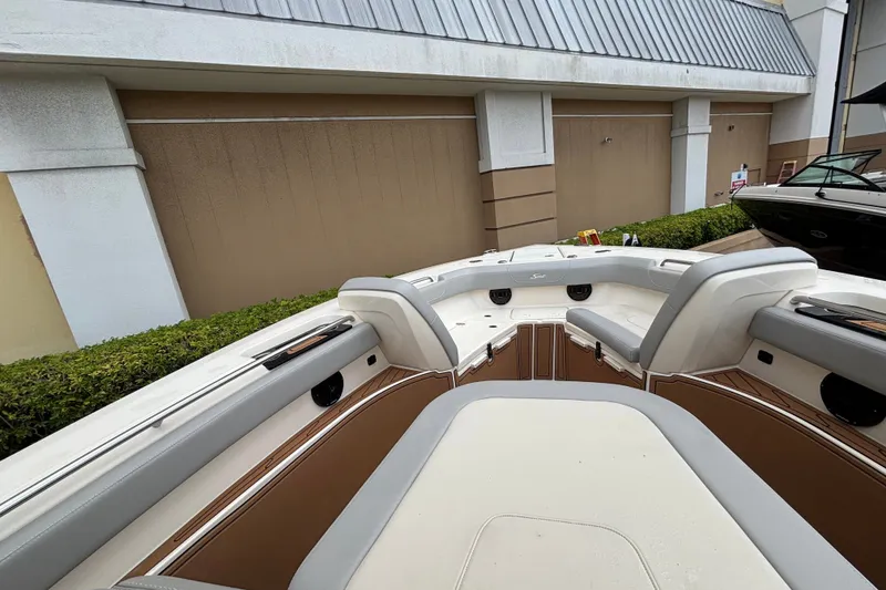 Slide: The Image of 2021 Scout 305 LXF boat interior with cushioned seating and sleek design. - 24