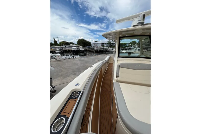 Slide: The Image of 2021 Scout 305 LXF boat docked, featuring sleek design and spacious deck. - 30