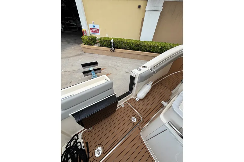 Slide: The Image of 2021 Scout 305 LXF boat interior with teak flooring and dockside view. - 33