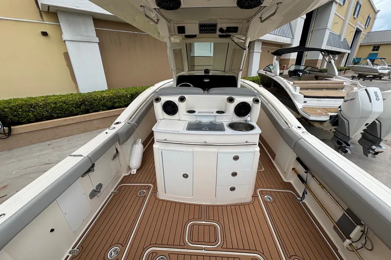 Slide: The Image of 2021 Scout 305 LXF boat interior with teak flooring and modern amenities. - 18