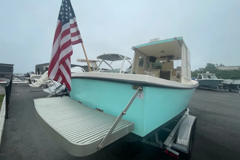 Slide: The Image of 1996 Rosborough Seaskiff 22 Wheelhouse Inboard with American flag, displayed on trailer. - 4