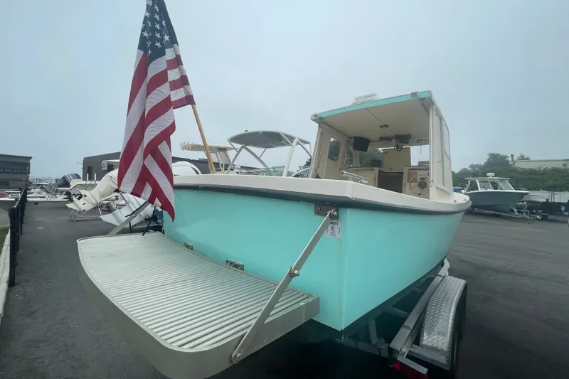 Slide: The Image of 1996 Rosborough Seaskiff 22 Wheelhouse Inboard with American flag, parked on trailer. - 5