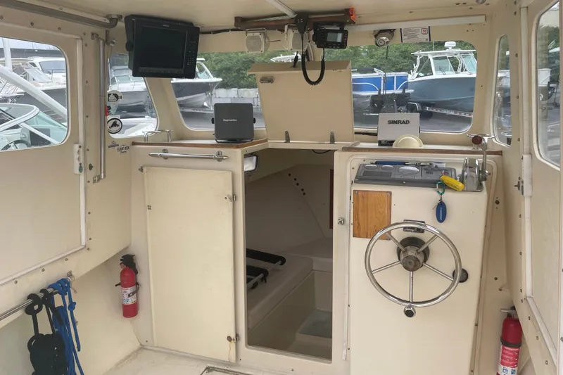 Slide: The Image of Interior of a 1996 Rosborough Seaskiff 22 Wheelhouse Inboard with navigation equipment. - 10
