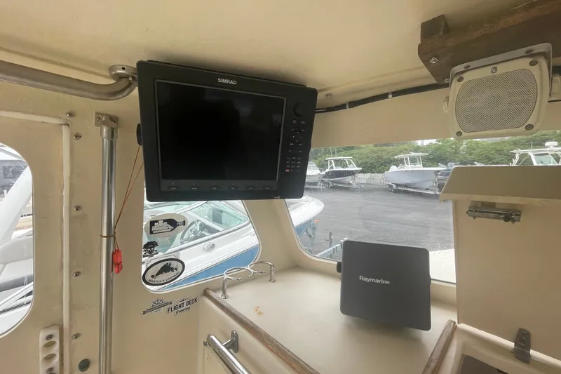 Slide: The Image of 1996 Rosborough Seaskiff 22 Wheelhouse interior with navigation equipment and speaker. - 13