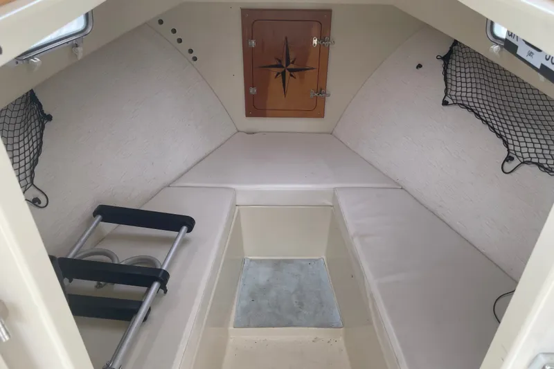 Slide: The Image of 1996 Rosborough Seaskiff 22 Wheelhouse Inboard cabin interior with seating and storage. - 11