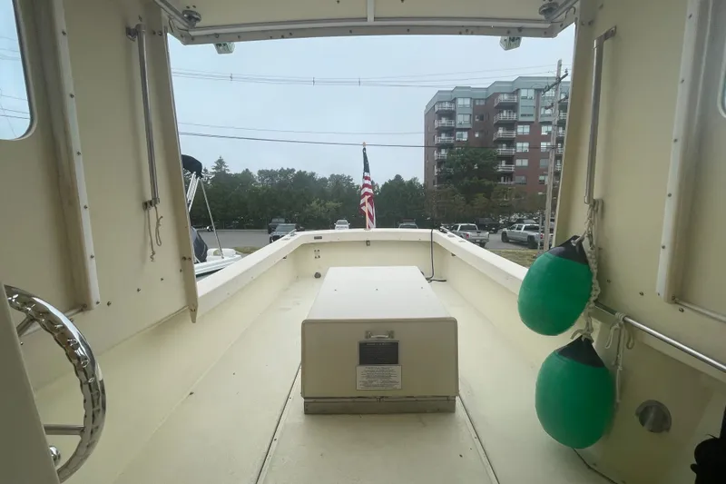 Slide: The Image of 1996 Rosborough Seaskiff 22 Wheelhouse Inboard boat interior with American flag and fenders. - 9