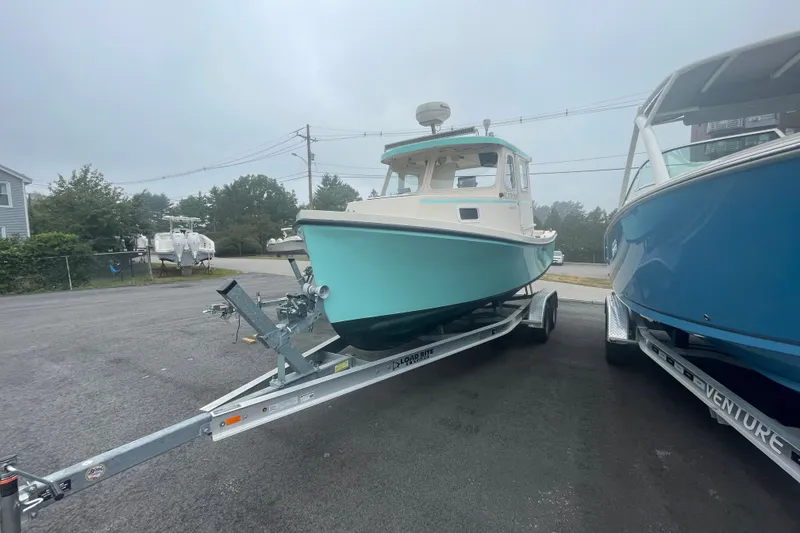 Slide: The Image of 1996 Rosborough Seaskiff 22 Wheelhouse Inboard on trailer, parked outdoors. - 2
