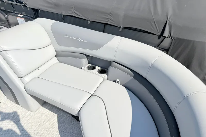 Slide: The Image of 2023 South Bay S224RS boat interior with plush seating and cup holders. - 7