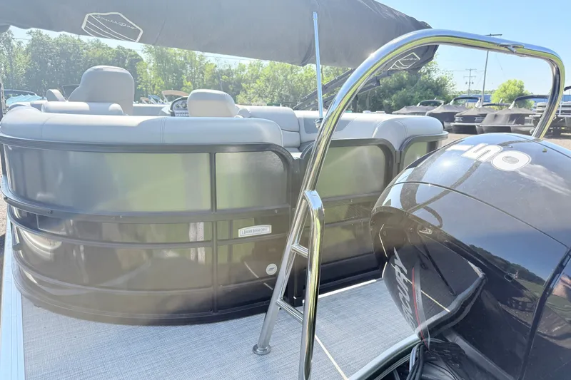 Slide: The Image of 2023 South Bay S224RS pontoon boat with sleek design and powerful outboard motor. - 14