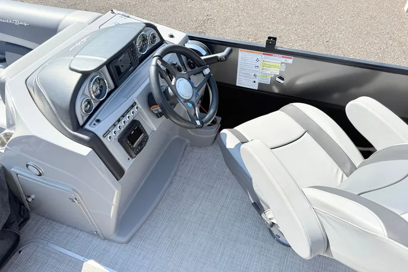 Slide: The Image of 2023 South Bay S224RS boat dashboard with steering wheel and controls. - 10