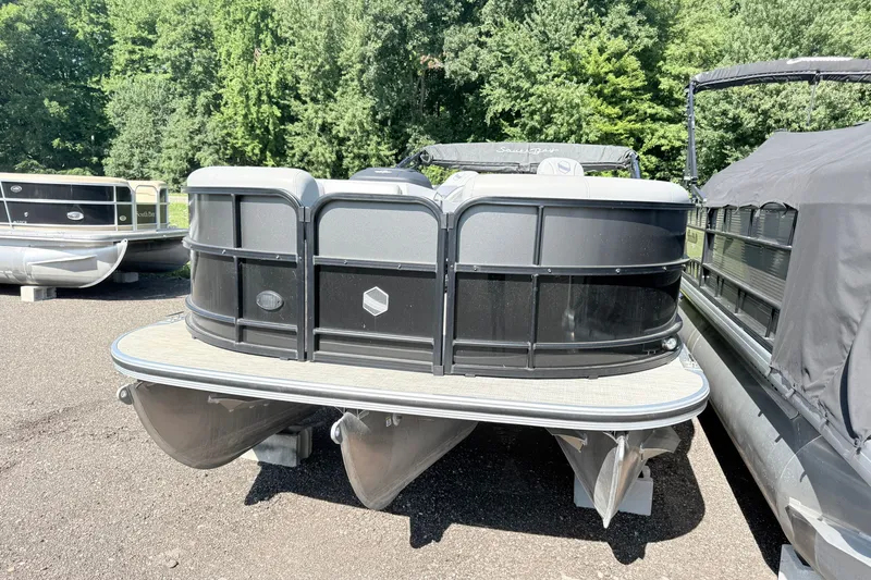 Slide: The Image of 2023 South Bay S224RS pontoon boat parked on a sunny day. - 2