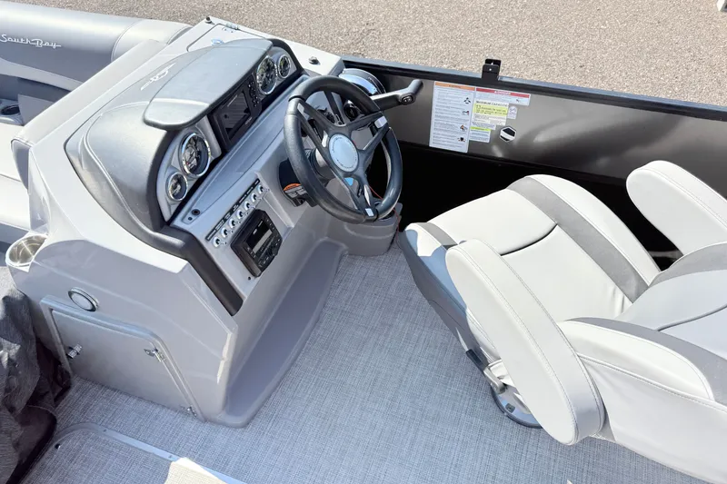 Slide: The Image of 2023 South Bay S224RS boat interior with steering wheel and control panel. - 9