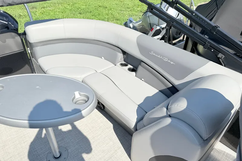 Slide: The Image of 2023 South Bay S224RS pontoon boat interior with gray seating and table. - 17