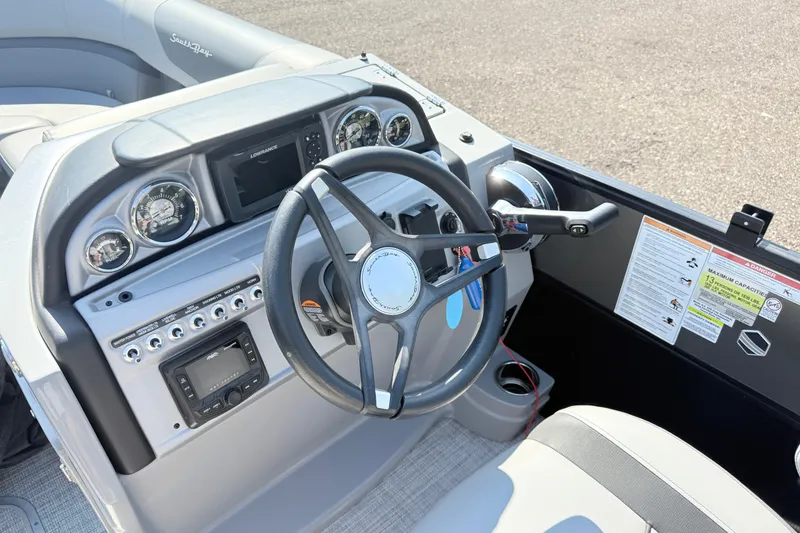 Slide: The Image of 2023 South Bay S224RS boat dashboard with steering wheel and control panel. - 12