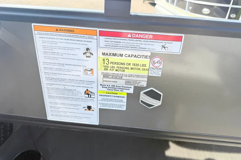 Slide: The Image of Warning and capacity labels on 2023 South Bay S224RS boat, detailing safety and weight limits. - 13