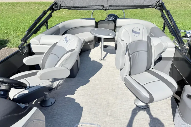 Slide: The Image of 2023 South Bay S224RS pontoon boat interior with plush seating and table. - 5