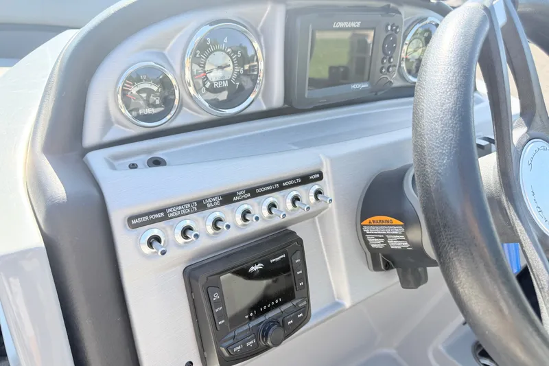 Slide: The Image of Dashboard of 2023 South Bay S224RS boat with gauges and control switches. - 11