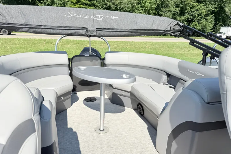Slide: The Image of 2023 South Bay S224RS pontoon boat interior with gray seating and table. - 8