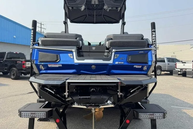 Slide: The Image of 2027 MasterCraft X23 boat rear view, showcasing sleek design and powerful engine. - 9