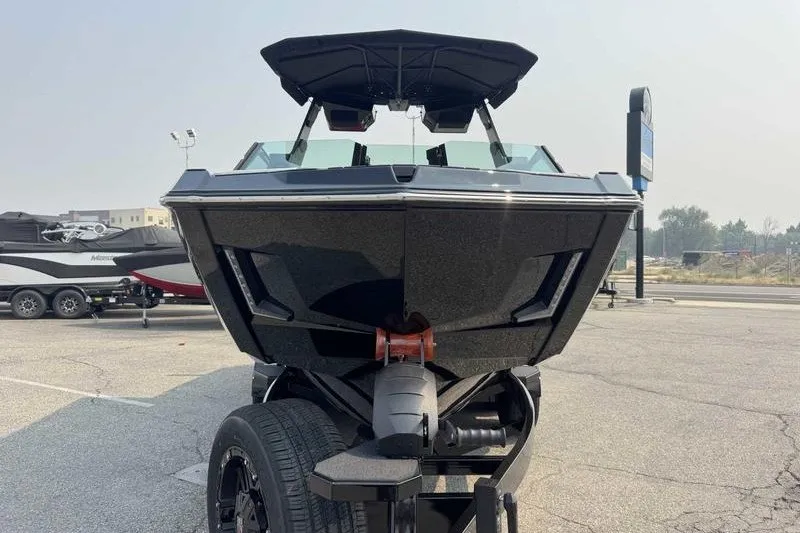 Slide: The Image of Front view of a 2027 MasterCraft X23 boat on a trailer in a parking lot. - 3