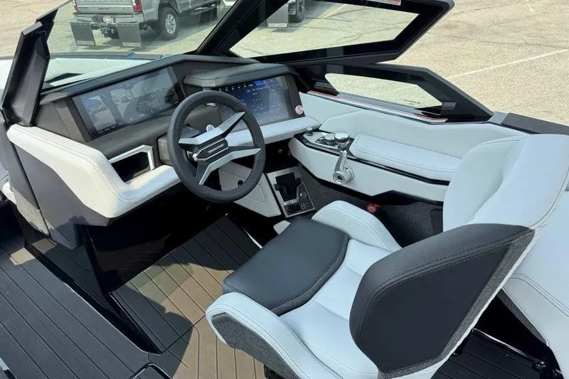 Slide: The Image of 2027 MasterCraft X23 boat interior with modern dashboard and sleek steering wheel design. - 11