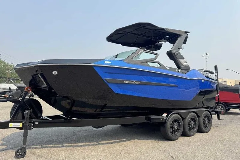 Slide: The Image of 2027 MasterCraft X23 boat in blue and black on a trailer. - 5