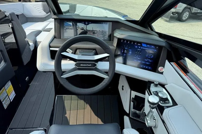 Slide: The Image of 2027 MasterCraft X23 boat cockpit with advanced digital displays and modern steering wheel. - 14