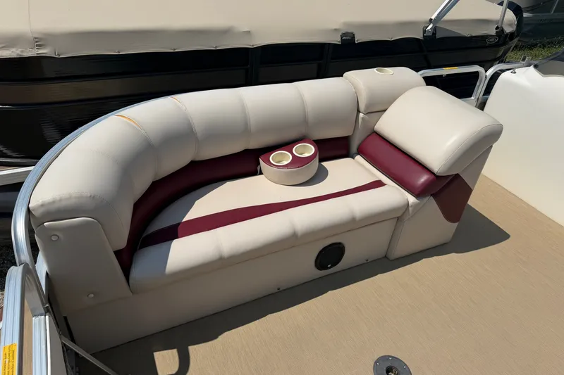 Slide: The Image of 2005 Tahoe Pontoon Sierra 20' boat interior with beige and maroon seating, cup holders. - 5