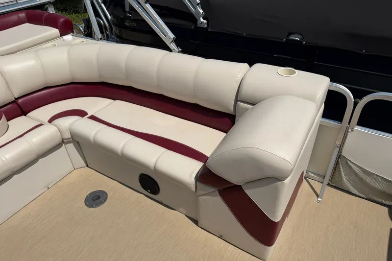 Slide: The Image of 2005 Tahoe Pontoon Sierra 20' boat interior with beige and maroon seating. - 12