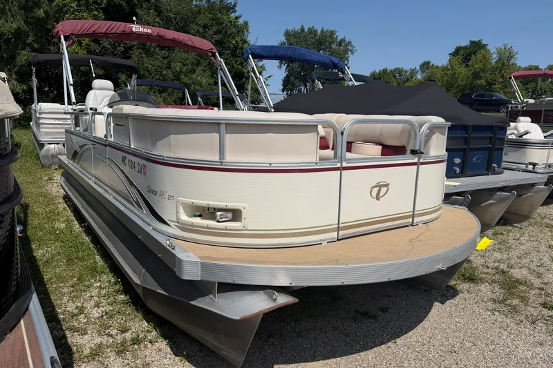 Slide: The Image of 2005 Tahoe Pontoon Sierra 20' boat with red canopy, parked on grass. - 1